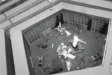 A plane crash is simulated inside the cardboard courtyard of a surprisingly realistic-looking model Pentagon. 
